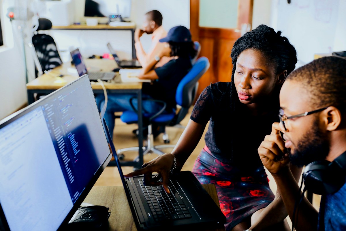 Developers reviewing code together on a laptop